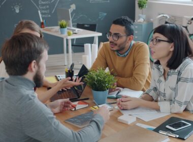 Diverse team collaborating around a table in office.