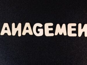 the word management written in white letters on a black background