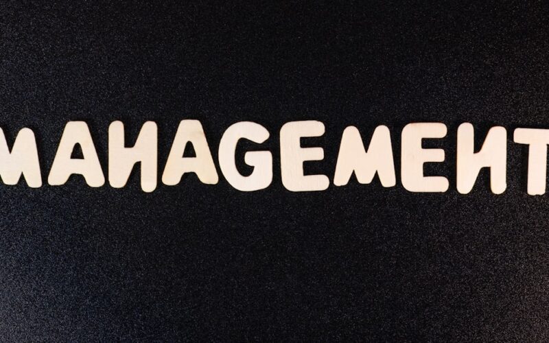 the word management written in white letters on a black background