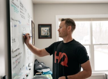 a man writing on a white board