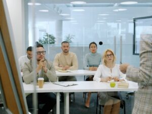 Business people attending a presentation in a modern office.