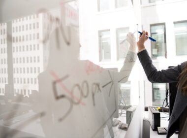 person writing on whiteboard