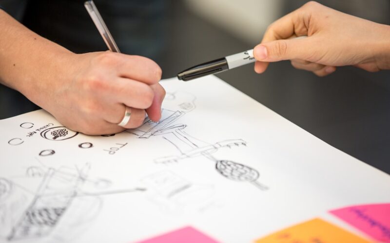 person writing on white paper