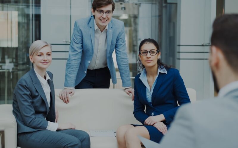 Four business professionals in a modern office meeting