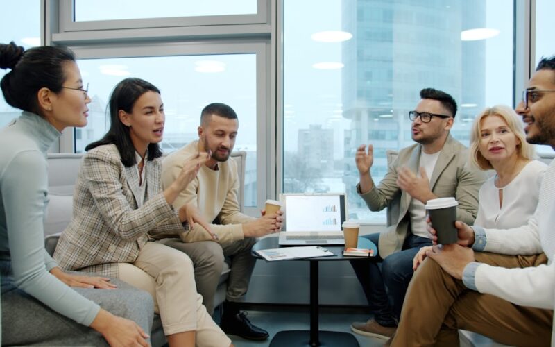 Diverse group of people in a modern office meeting.