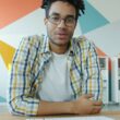 Man with dreadlocks talking on video call