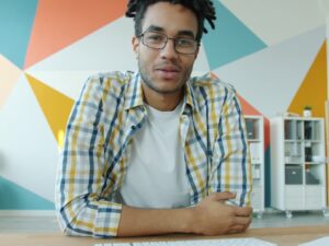 Man with dreadlocks talking on video call