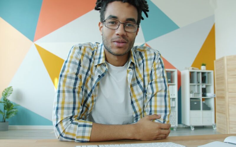 Man with dreadlocks talking on video call