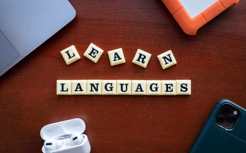 the word learn languages spelled out of scrabble tiles