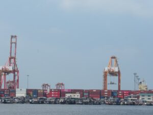 Shipping containers and cranes at a busy port.