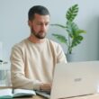 Man working on a laptop at a desk.