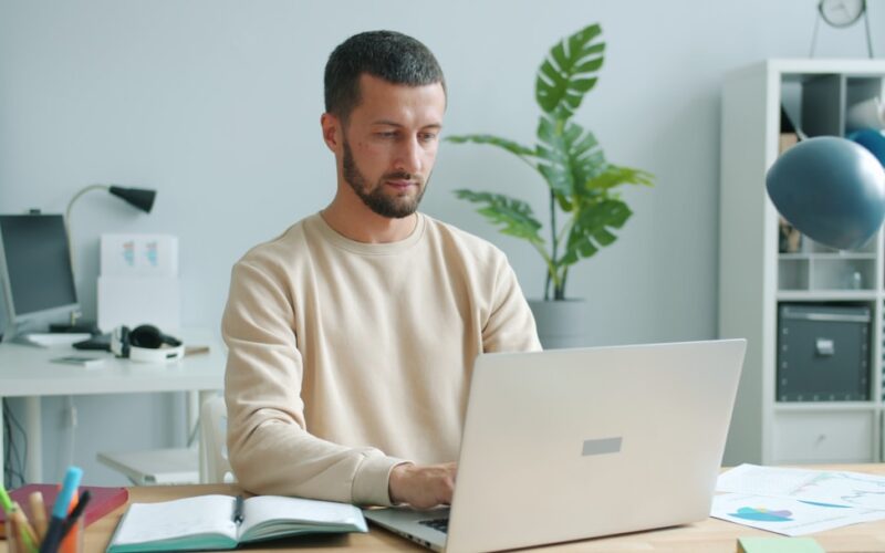 Man working on a laptop at a desk.