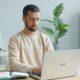 Man working on a laptop at a desk.